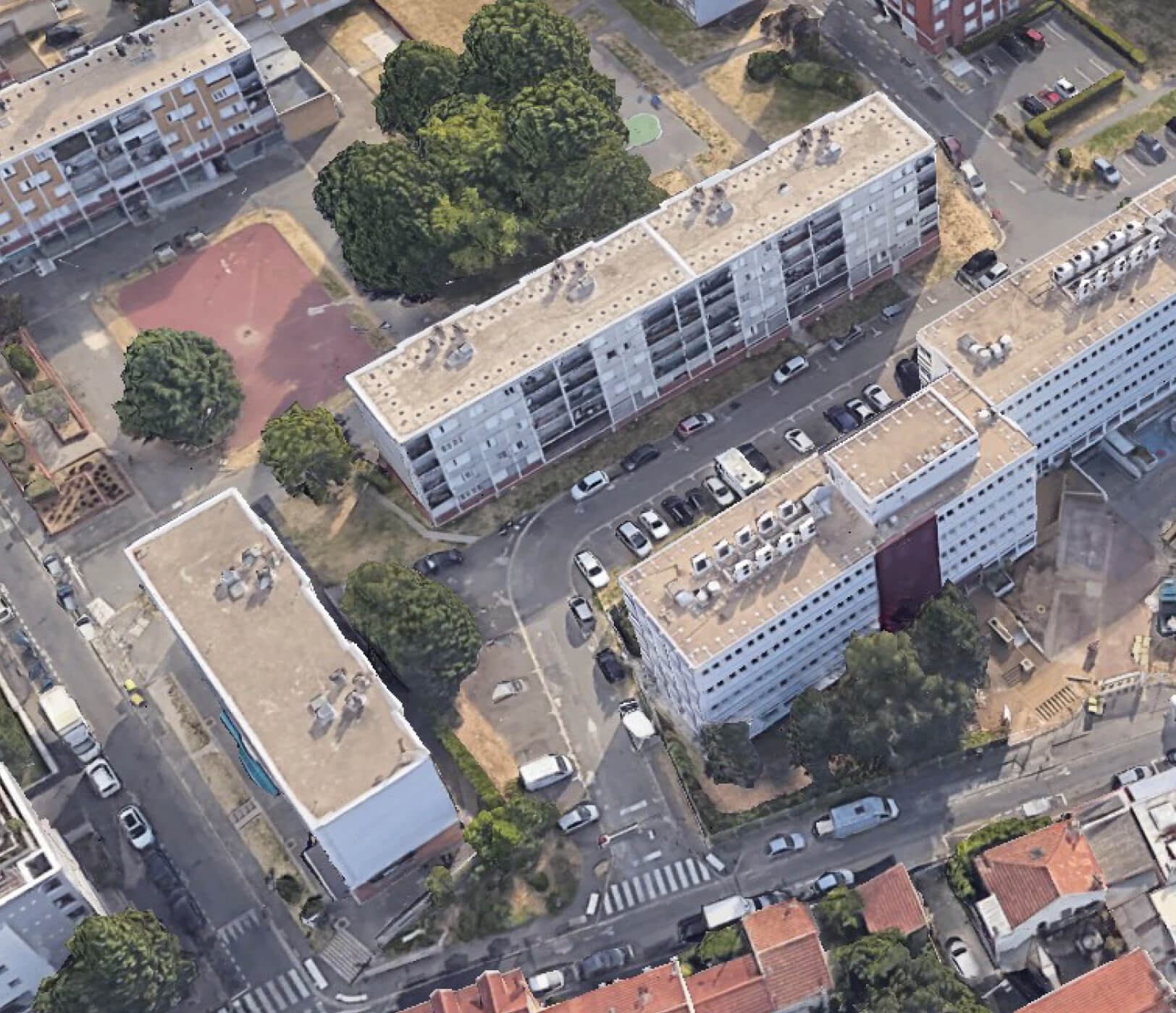 Photo aérienne représentant les immeubles et les rues du site du projet d’extension et d’aménagement du siège d’Est Ensemble Habitat