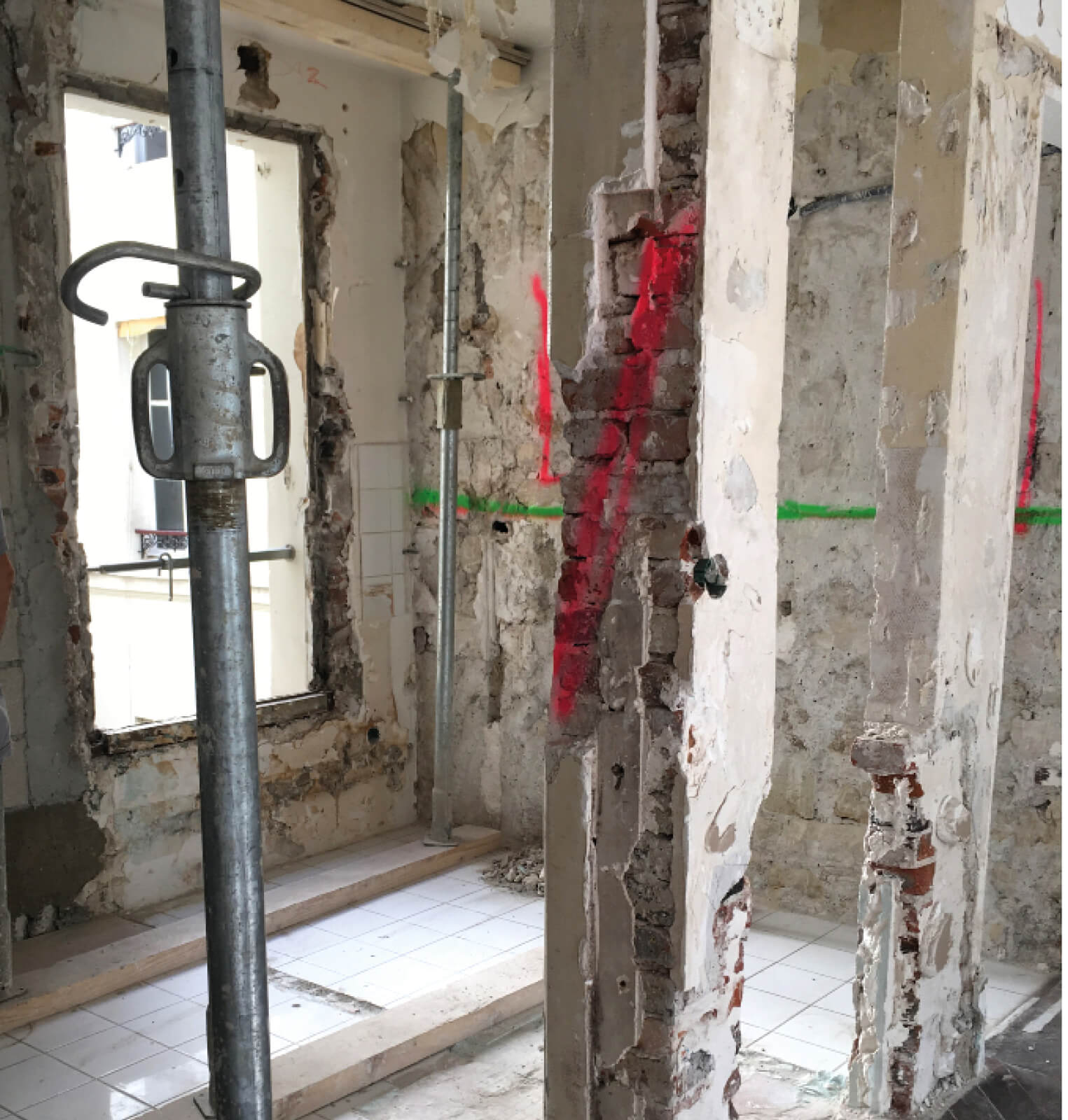 Photo de travaux lourds sur des piliers, murs et menuiseries pendant le projet de restructuration et réhabilitation rue Sauffroy